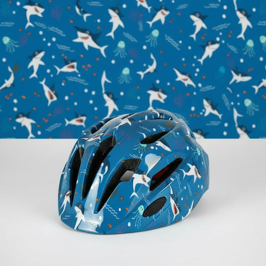 Casque de vélo pour enfant bleu foncé avec des motifs amusants de requins blancs, méduses et étoiles de mer, doté de nombreuses aérations pour la fraîcheur.